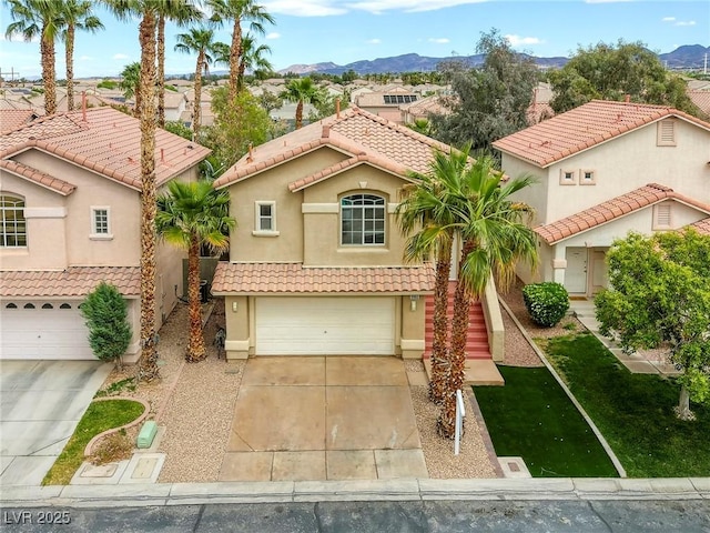 9966 Mystic Moss St, Las Vegas, NV 89183 - mediterranean / spanish-style home with stucco siding, a tiled roof, a garage, a mountain view, and concrete driveway