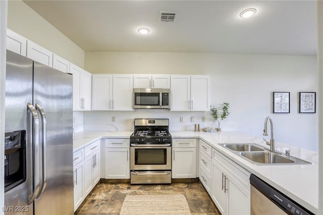 9966 Mystic Moss St, Las Vegas, NV 89183 - kitchen with white cabinetry, appliances with stainless steel finishes, and a sink