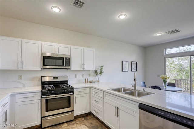 9966 Mystic Moss St, Las Vegas, NV 89183 - kitchen with white cabinetry, visible vents, appliances with stainless steel finishes, and a sink