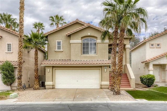 9966 Mystic Moss St, Las Vegas, NV 89183 - view of front of home with central AC unit, stucco siding, concrete driveway, and an attached garage