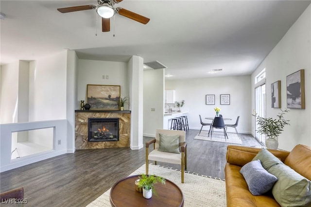 9966 Mystic Moss St, Las Vegas, NV 89183 - living area with baseboards, wood finished floors, ceiling fan, and a fireplace