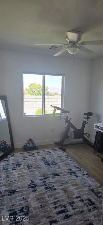 314 W Winston Ln, Indian Springs, NV 89018 - empty room with a ceiling fan, a healthy amount of sunlight, wood finished floors, and baseboards