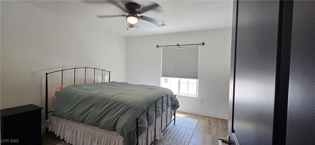 314 W Winston Ln, Indian Springs, NV 89018 - bedroom featuring wood finished floors, a ceiling fan, visible vents, and baseboards