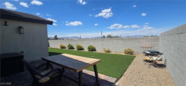 314 W Winston Ln, Indian Springs, NV 89018 - view of yard featuring a mountain view, fence, and a patio area