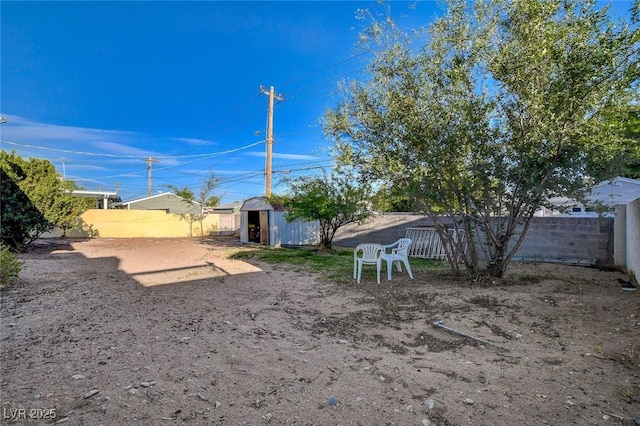 709 New Mexico St, Boulder City, NV 89005 - view of yard featuring an outdoor structure, a shed, and a fenced backyard