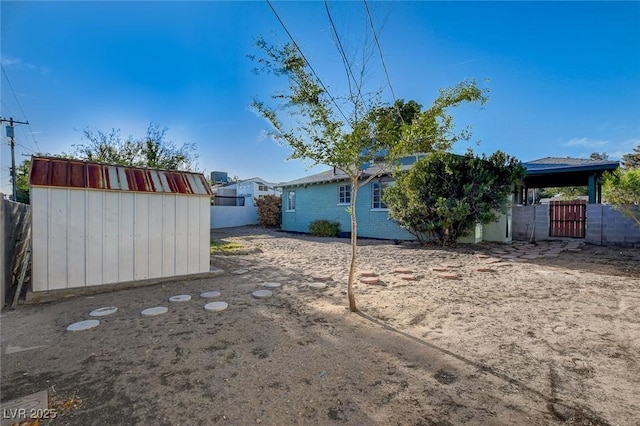 709 New Mexico St, Boulder City, NV 89005 - view of yard featuring a storage unit, fence, and an outdoor structure