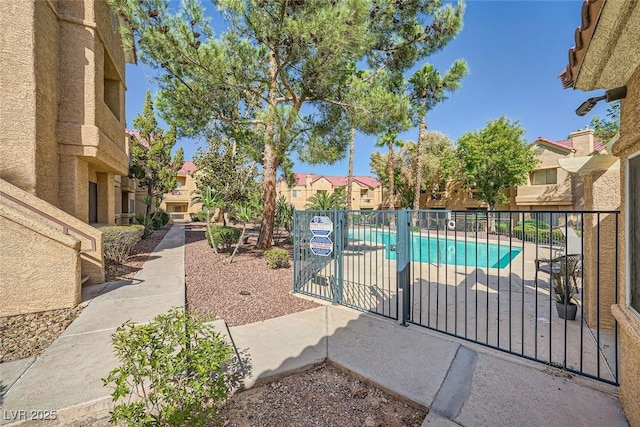 pool featuring fence, a gate, and a residential view