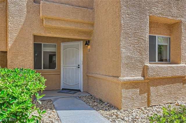 entrance to property with stucco siding