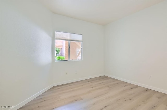 unfurnished room featuring light wood-type flooring and baseboards