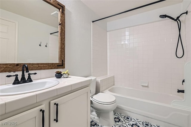bathroom with tile patterned floors, vanity, toilet, and tub / shower combination