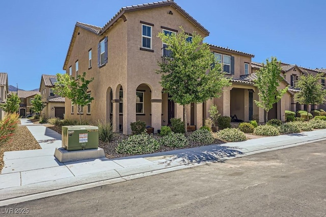 view of front of property featuring a tile roof and stucco siding