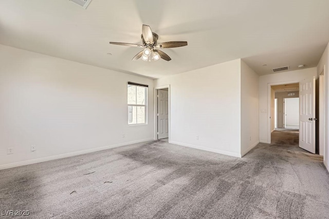 spare room with ceiling fan, carpet, and baseboards