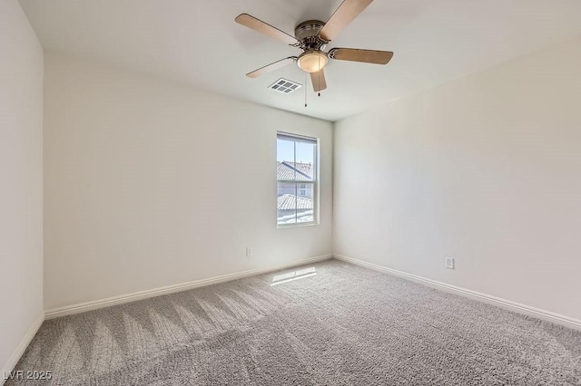 spare room with carpet flooring, baseboards, and ceiling fan