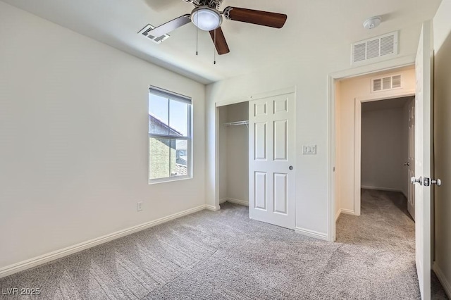 unfurnished bedroom featuring carpet, baseboards, a closet, and a ceiling fan