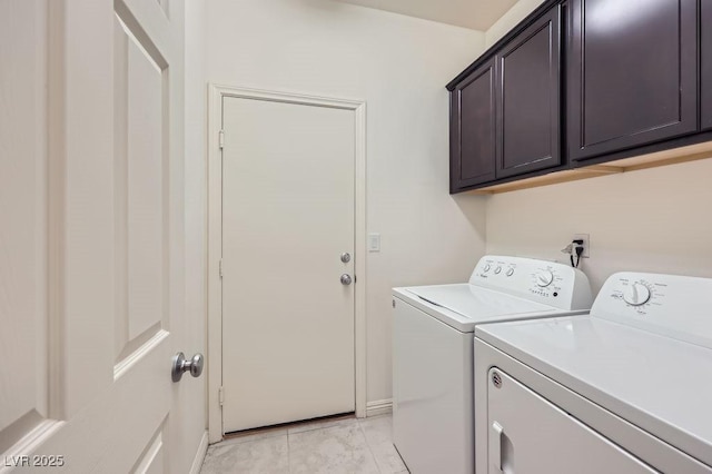laundry room featuring washer and clothes dryer, cabinet space, and baseboards