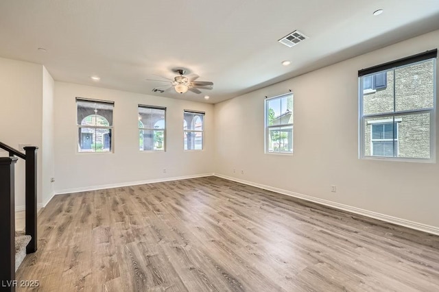 unfurnished living room with a ceiling fan, wood finished floors, baseboards, and recessed lighting