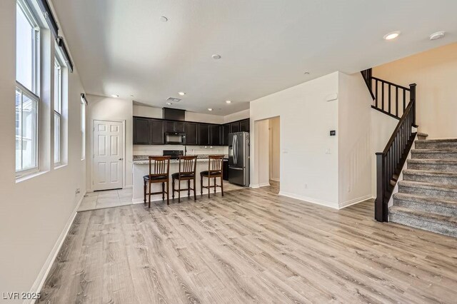 2862 Starling Summit St, Henderson, NV 89044 - living room with baseboards, light wood-style floors, stairs, and recessed lighting