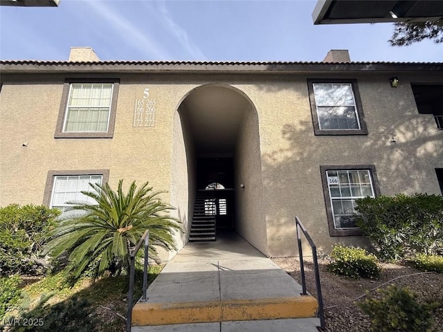property entrance with stucco siding