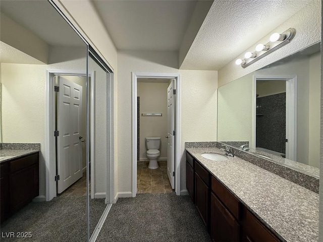 full bathroom with baseboards, toilet, and vanity