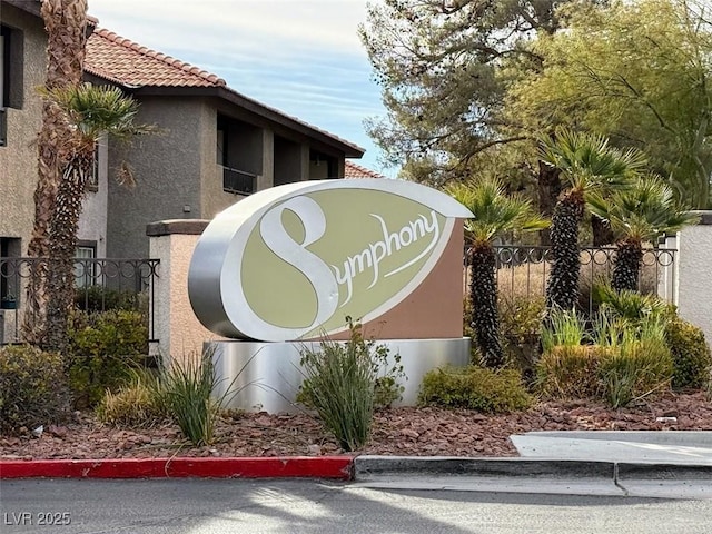 community / neighborhood sign with fence