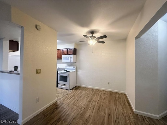 kitchen with ceiling fan, baseboards, wood finished floors, and white appliances