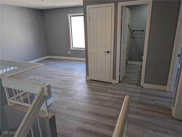 2716 Knightsbridge Rd, Henderson, NV 89074 - unfurnished bedroom with a textured ceiling, wood finished floors, and baseboards