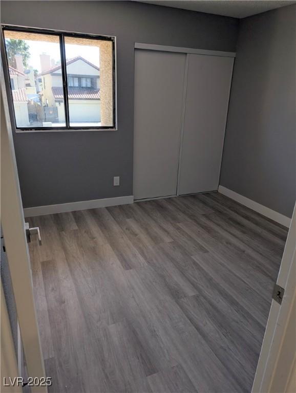 2716 Knightsbridge Rd, Henderson, NV 89074 - unfurnished bedroom with baseboards, wood finished floors, and a closet