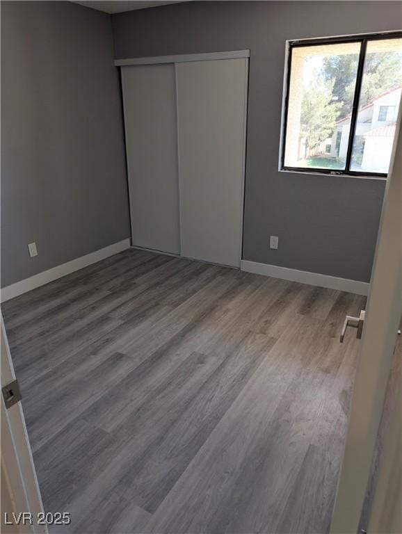 2716 Knightsbridge Rd, Henderson, NV 89074 - unfurnished bedroom featuring baseboards, wood finished floors, and a closet