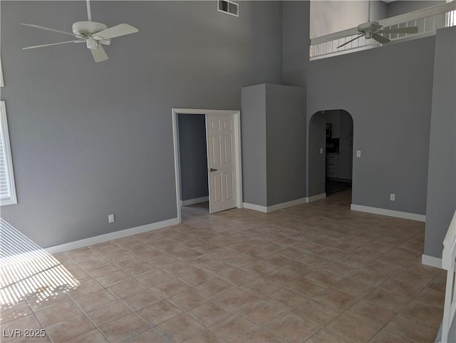 2716 Knightsbridge Rd, Henderson, NV 89074 - unfurnished room with arched walkways, ceiling fan, baseboards, visible vents, and a towering ceiling