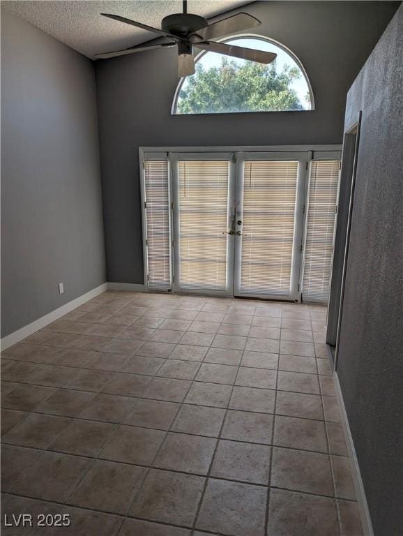 2716 Knightsbridge Rd, Henderson, NV 89074 - tiled spare room featuring a textured ceiling, ceiling fan, french doors, and a high ceiling