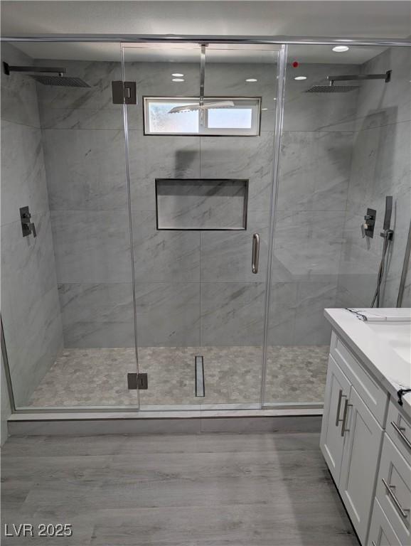 2716 Knightsbridge Rd, Henderson, NV 89074 - bathroom with a shower stall, wood finished floors, and vanity