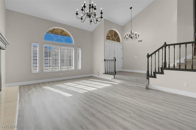 8232 Ocean Terrace Way, Las Vegas, NV 89128 - entryway with wood finished floors, stairway, a chandelier, baseboards, and high vaulted ceiling