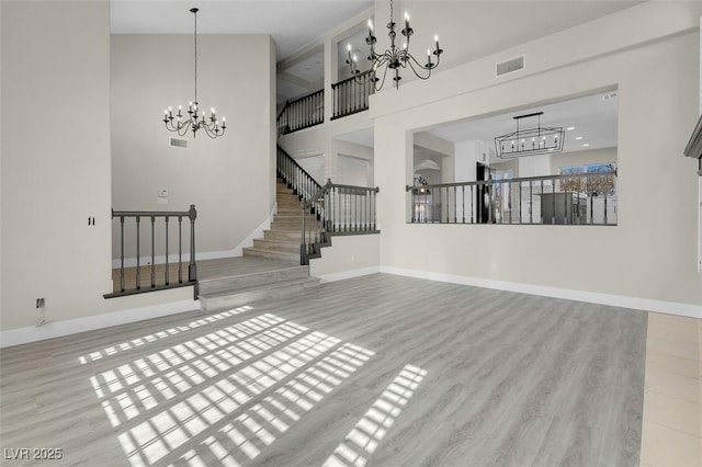 8232 Ocean Terrace Way, Las Vegas, NV 89128 - unfurnished living room featuring stairway, a chandelier, visible vents, and baseboards