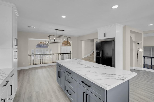 8232 Ocean Terrace Way, Las Vegas, NV 89128 - kitchen featuring gray cabinetry, white cabinets, light wood finished floors, and black fridge with ice dispenser