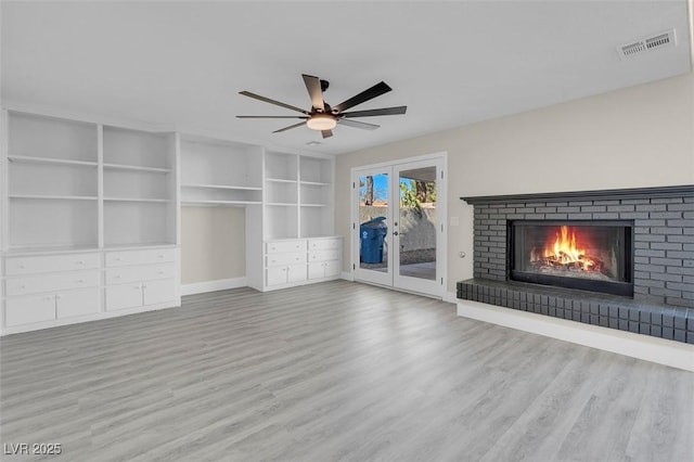 8232 Ocean Terrace Way, Las Vegas, NV 89128 - unfurnished living room featuring visible vents, ceiling fan, baseboards, a brick fireplace, and wood finished floors