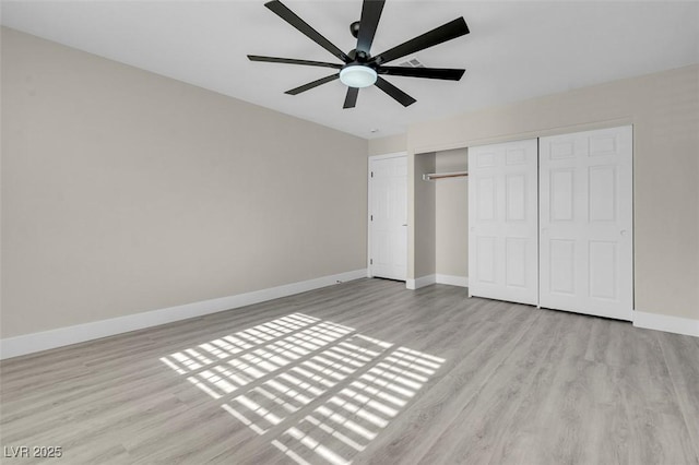 8232 Ocean Terrace Way, Las Vegas, NV 89128 - unfurnished bedroom featuring baseboards, wood finished floors, a ceiling fan, and a closet