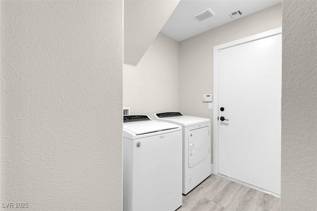 8232 Ocean Terrace Way, Las Vegas, NV 89128 - laundry room featuring light wood finished floors, visible vents, washing machine and clothes dryer, and laundry area
