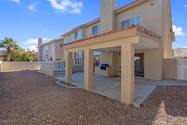 8232 Ocean Terrace Way, Las Vegas, NV 89128 - back of property featuring a patio area, a tiled roof, a chimney, stucco siding, and fence