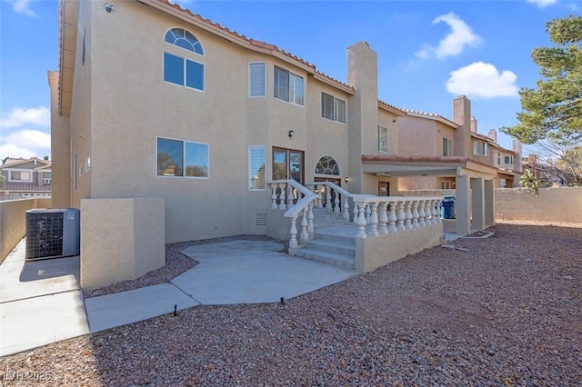 8232 Ocean Terrace Way, Las Vegas, NV 89128 - back of house featuring a chimney, stucco siding, fence, central air condition unit, and a tile roof