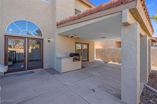 8232 Ocean Terrace Way, Las Vegas, NV 89128 - property entrance with french doors, stucco siding, a tile roof, and a patio area