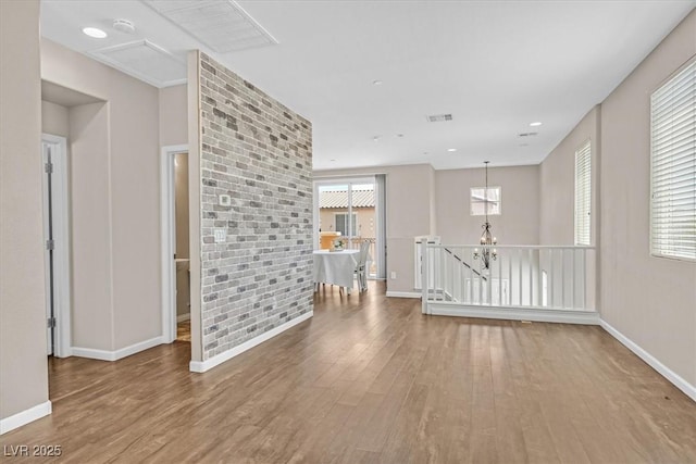 empty room with baseboards and wood finished floors
