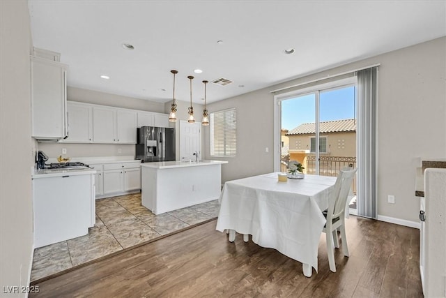 dining room with recessed lighting, visible vents, light wood-style flooring, and plenty of natural light
