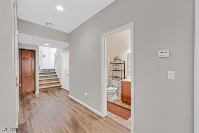 1121 Via Castelli, Henderson, NV 89052 - corridor featuring stairway, baseboards, visible vents, and light wood-style floors