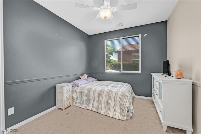 bedroom featuring baseboards, visible vents, light carpet, and ceiling fan