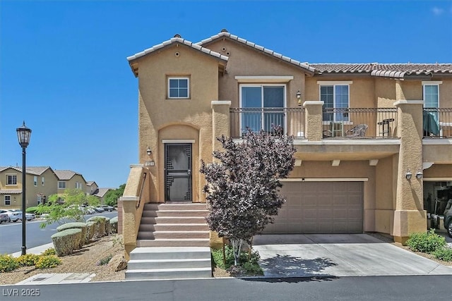 1121 Via Castelli, Henderson, NV 89052 - view of front of property featuring a balcony, a tiled roof, a garage, stucco siding, and concrete driveway