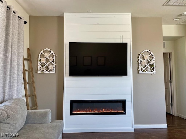 1121 Via Castelli, Henderson, NV 89052 - living area featuring a large fireplace, baseboards, dark wood-style floors, and visible vents