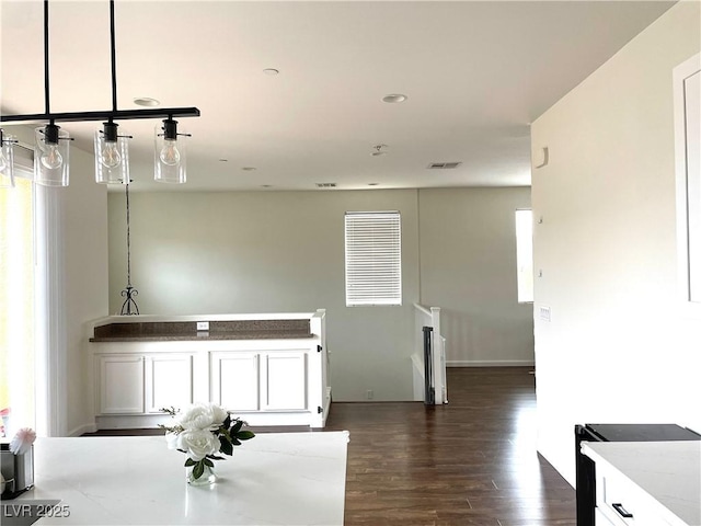 1121 Via Castelli, Henderson, NV 89052 - kitchen featuring light stone counters, visible vents, pendant lighting, dark wood-style flooring, and white cabinets