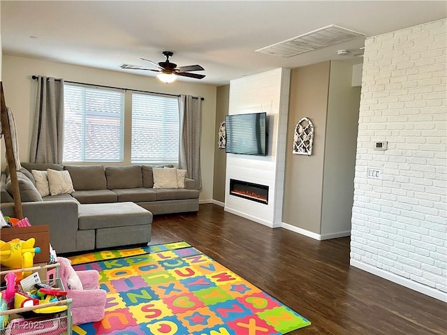 1121 Via Castelli, Henderson, NV 89052 - living area with a ceiling fan, baseboards, brick wall, wood finished floors, and a large fireplace