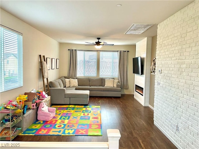 1121 Via Castelli, Henderson, NV 89052 - living room with a ceiling fan, dark wood-style floors, visible vents, and plenty of natural light