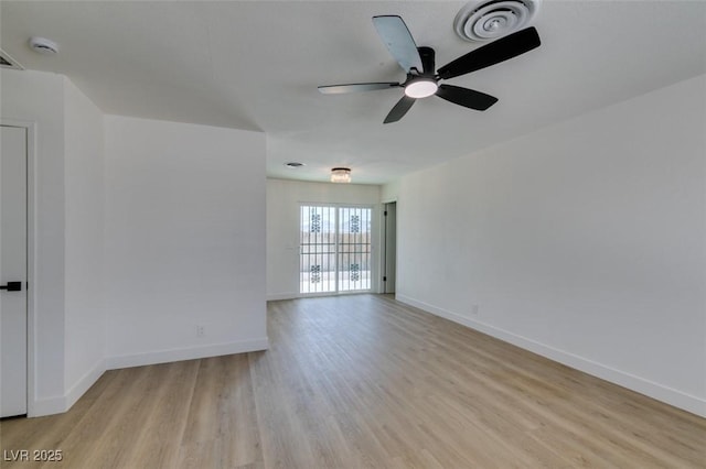 empty room featuring baseboards, visible vents, ceiling fan, and light wood finished floors